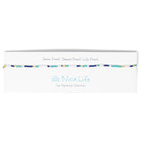 Navy and teal baded choker shown on a Nica life branded card. 