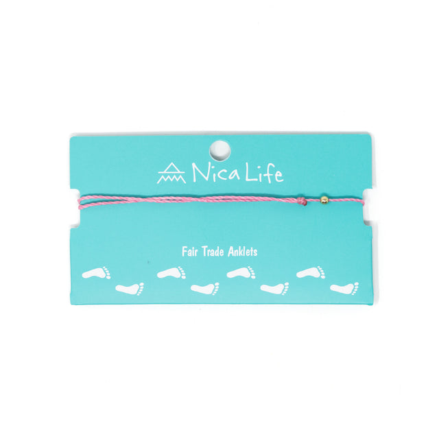 Pink thread anklet with a single gold filled bead shown on a teal Nica Life branded card