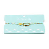 Pastel rainbow color beaded charm bar anklet with carabiner clasp for charms show on teal Nica Life branded card