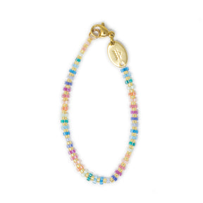 Hand beaded bag charm in bright fun pastel rainbow colors show on white