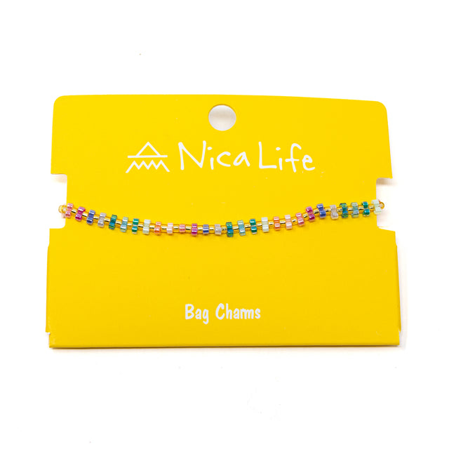 Colorful beaded bag charm on a yellow card with 'Nica Life' branding.