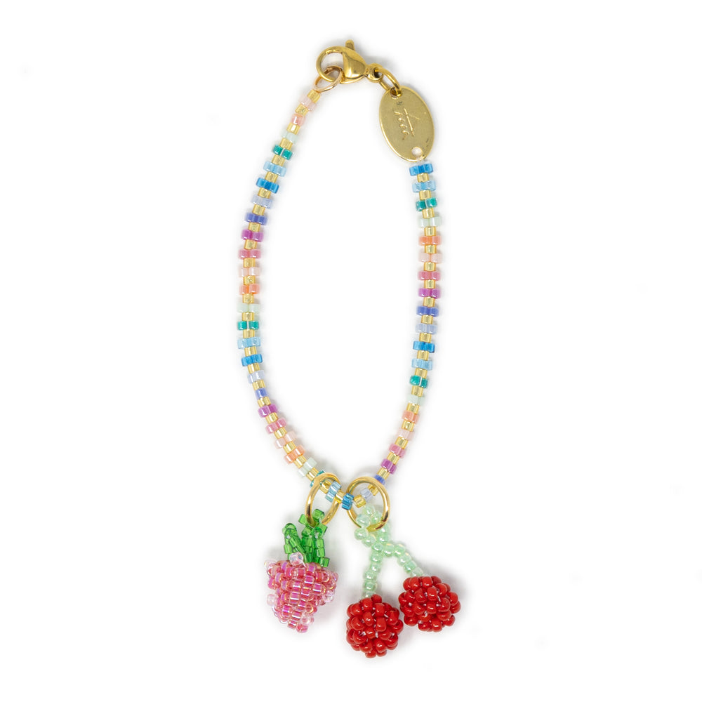 Colorful beaded bag charm with fruit charms on a white background