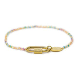 Multicolored beaded charm bar bracelet with gold carabiner clasp for charms on a white background