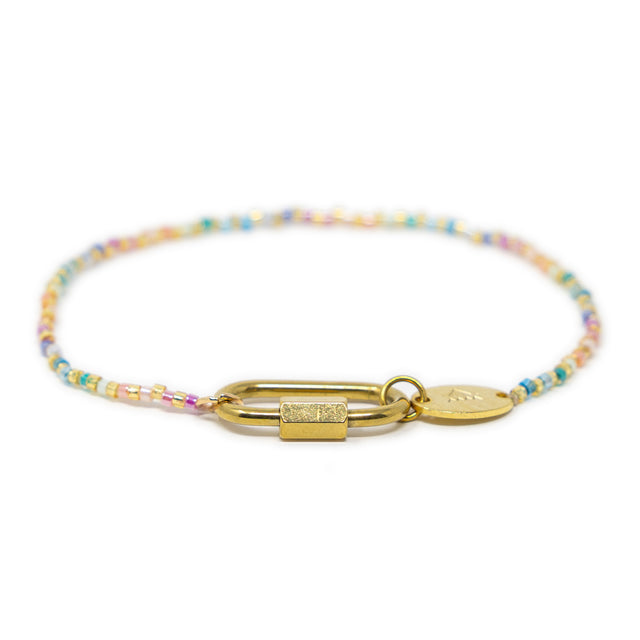 Multicolored beaded charm bar bracelet with gold carabiner clasp for charms on a white background