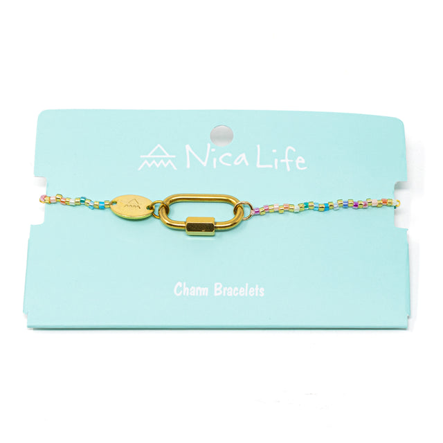 Colorful beaded charm bar bracelet with a carabiner clsap for charms on a teal Nica Life branded card