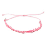 Bright pink string knot anklet on white front view