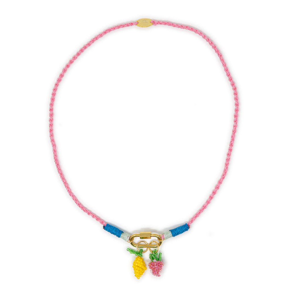 Pink hand braided rope charm necklace with lemon & strawberry beaded charms shown on white