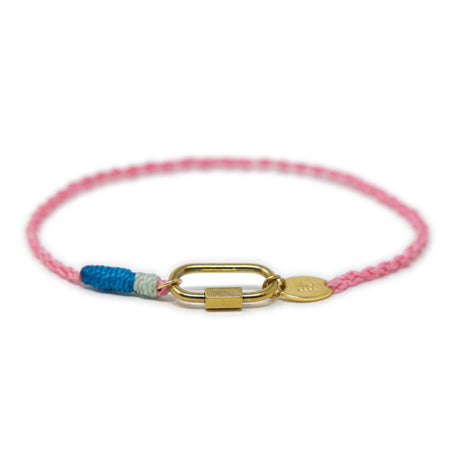 Anklet with pink cord, blue accent, and gold carabiner clasp for charms on a white background