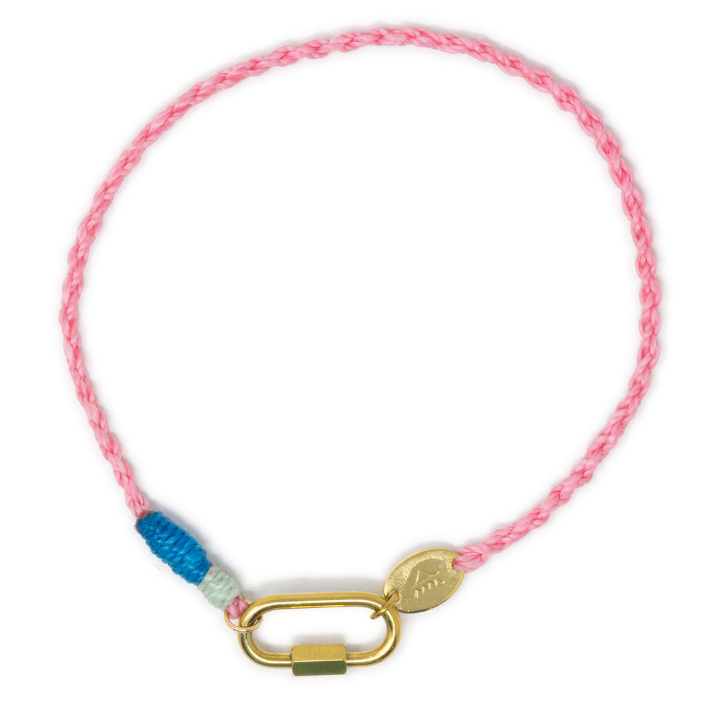 Hand braided pink cord charm anklet with blue accents & a gold carabiner clasp for charms shown on white