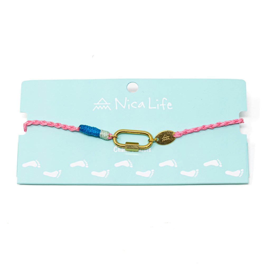 Anklet with pink and blue hand braided cord with a gold carabiner for charms on a Nica Life branded card