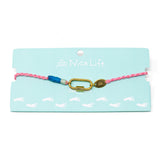 Anklet with pink and blue hand braided cord with a gold carabiner for charms on a Nica Life branded card