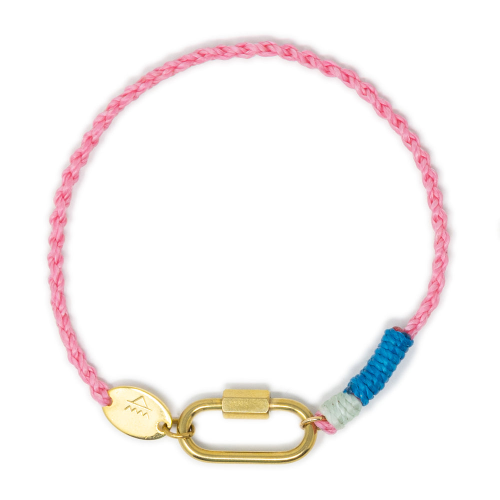 Hand braided cord charm bracelet in pink with blue cord and gold carabiner clasp on a white background