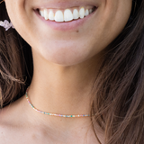 Close-up of a person wearing a colorful beaded  waterproof choker necklace 