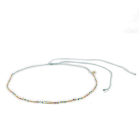 Beaded waterproof choker in pastel rainbow colors on a white background