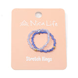 Set of twp tone purple beaded stretch rings on a pink 'Nica Life' branded card shown on white