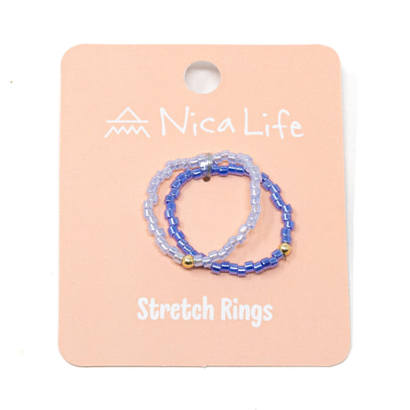 Set of twp tone purple beaded stretch rings on a pink 'Nica Life' branded card shown on white