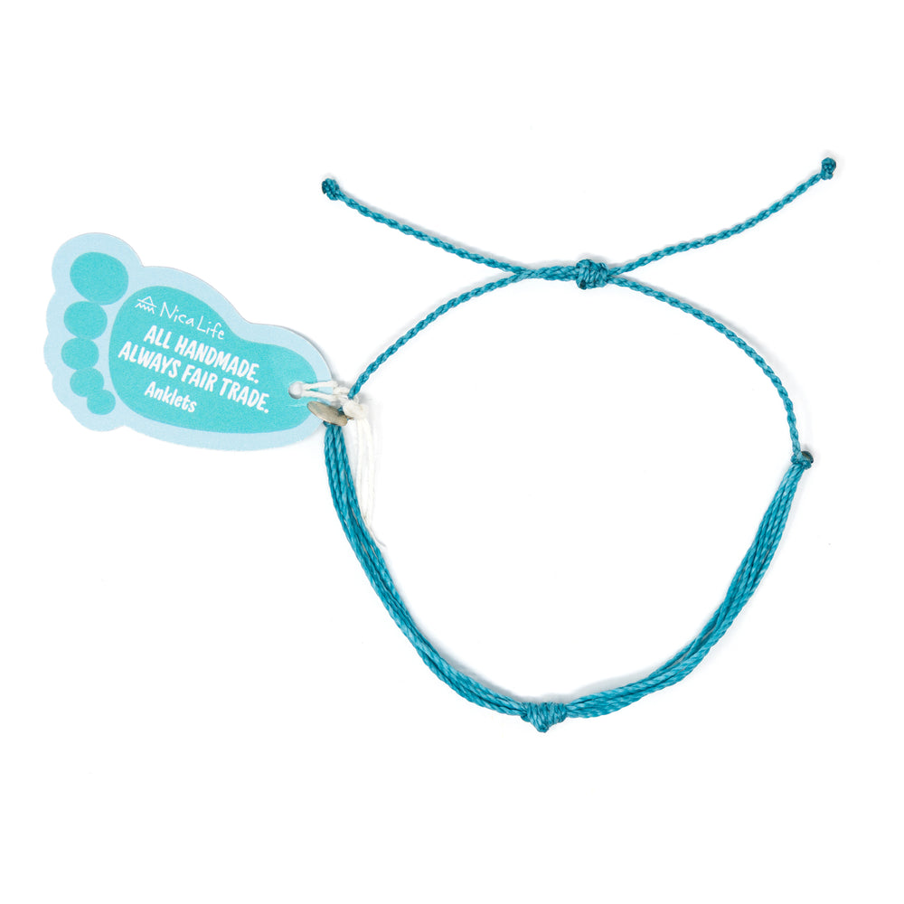 Teal string knot anklet with a Nica Life branded foot shaped tag shown on white