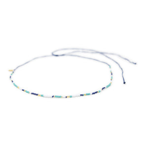 Beaded navy teal gold waterproof choker necklace for surfers on white