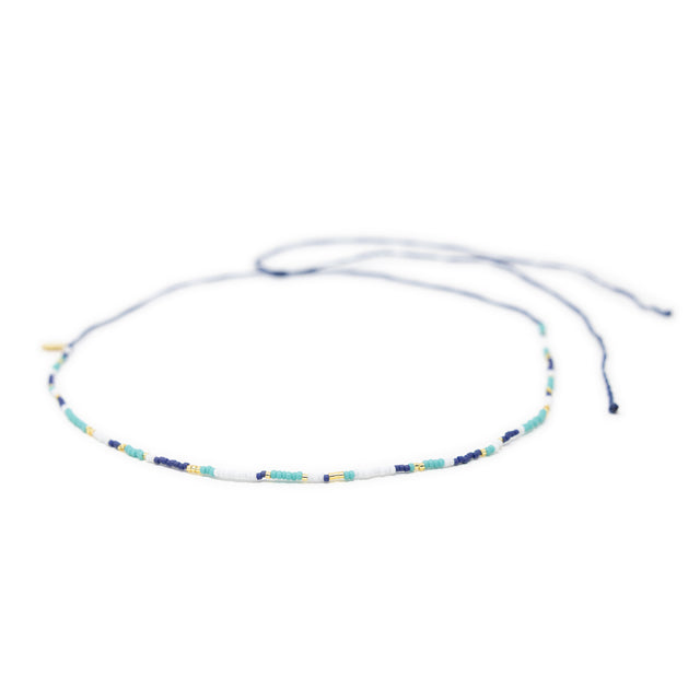 Beaded navy teal gold waterproof choker necklace for surfers on white