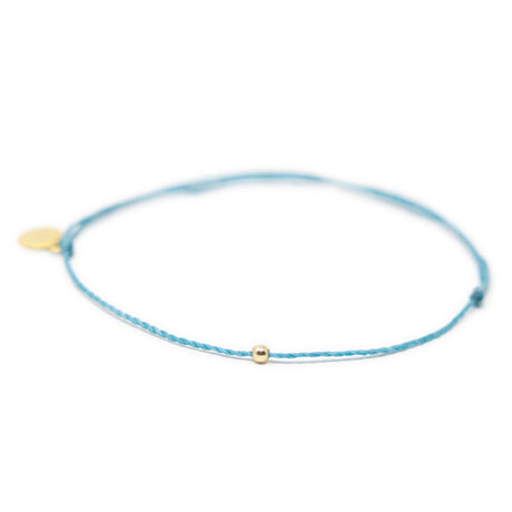 Teal thread anklet with one gold filled bead on white front view