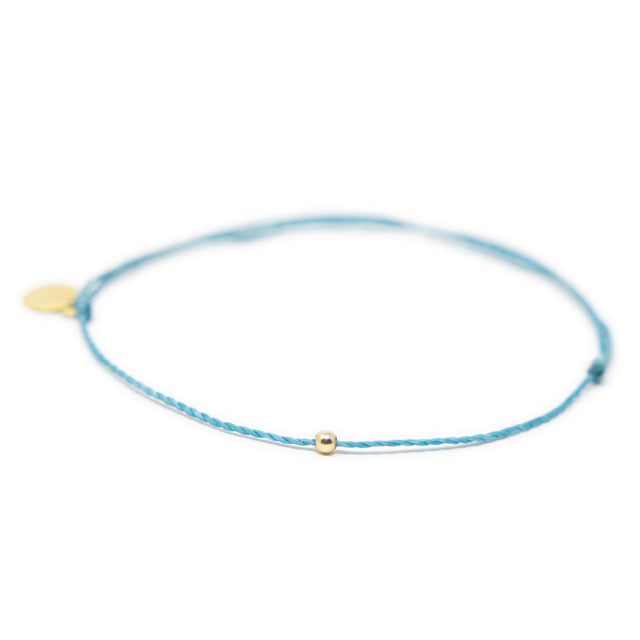 Teal thread anklet with one gold filled bead on white front view