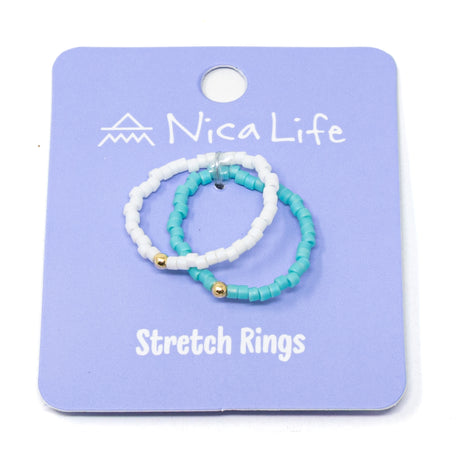 Set of turquoise and white beaded stretch rings on a purple Nica Life branded card.
