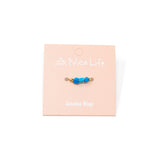 Turquioise stone & gold ring on Nica Life branded card