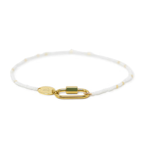 White & gold beaded charm bar anklet with carabiner clasp for charms shown on white front view