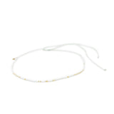 White & gold waterproof choker necklace for surfer girls on white background, adjustable with waterproof cord