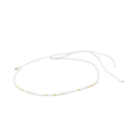 White & gold waterproof choker necklace for surfer girls on white background, adjustable with waterproof cord