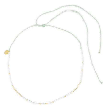 White waterproof surfer girl choker necklace with gold accents on a white background