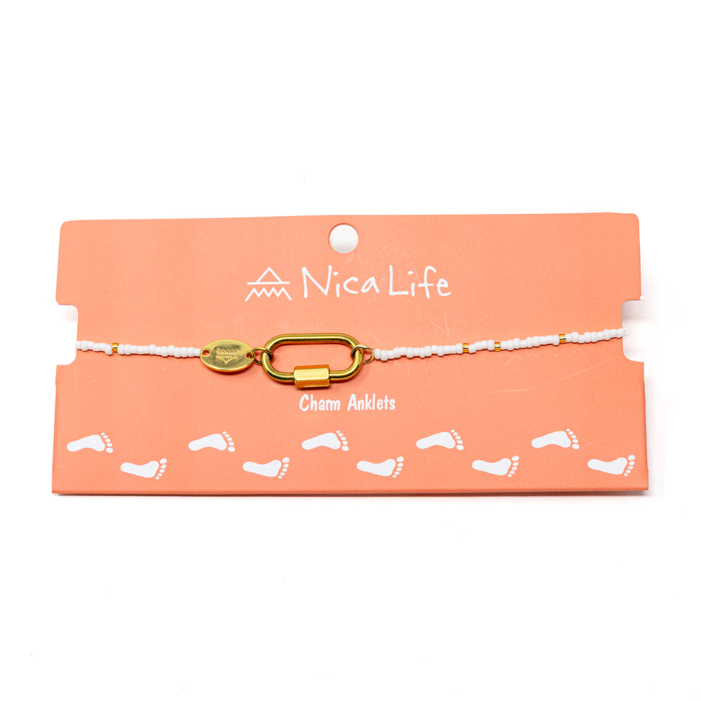 White & gold charm bar anklet with carabiner for charms shown on a coral Nica Life branded card