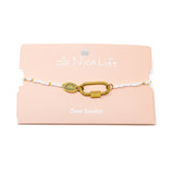 White & gold bead bracelet with lock charm on a pink 'NicaLife' branded card