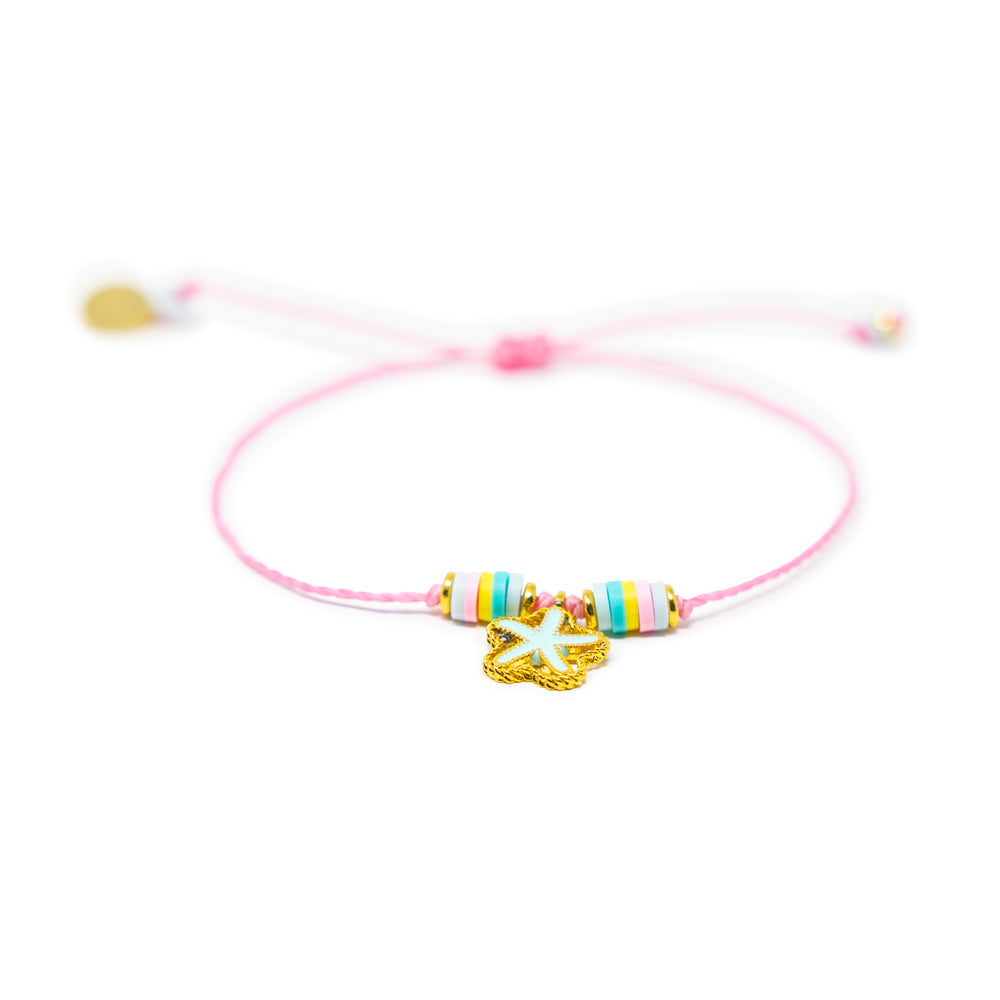 Pink string bracelet with colorful beads and a mint color starfish charm shown on white from the front
