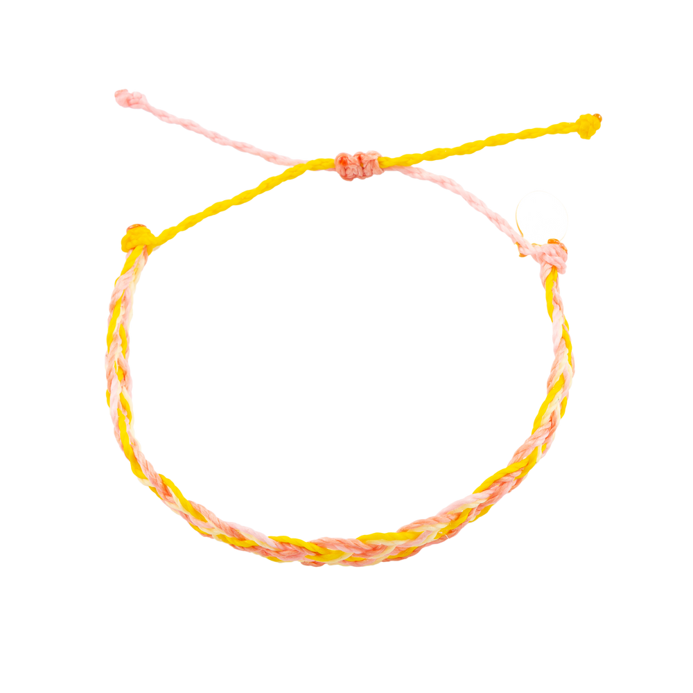 A pink yellow and coral flat braided bracelet shown on white from top