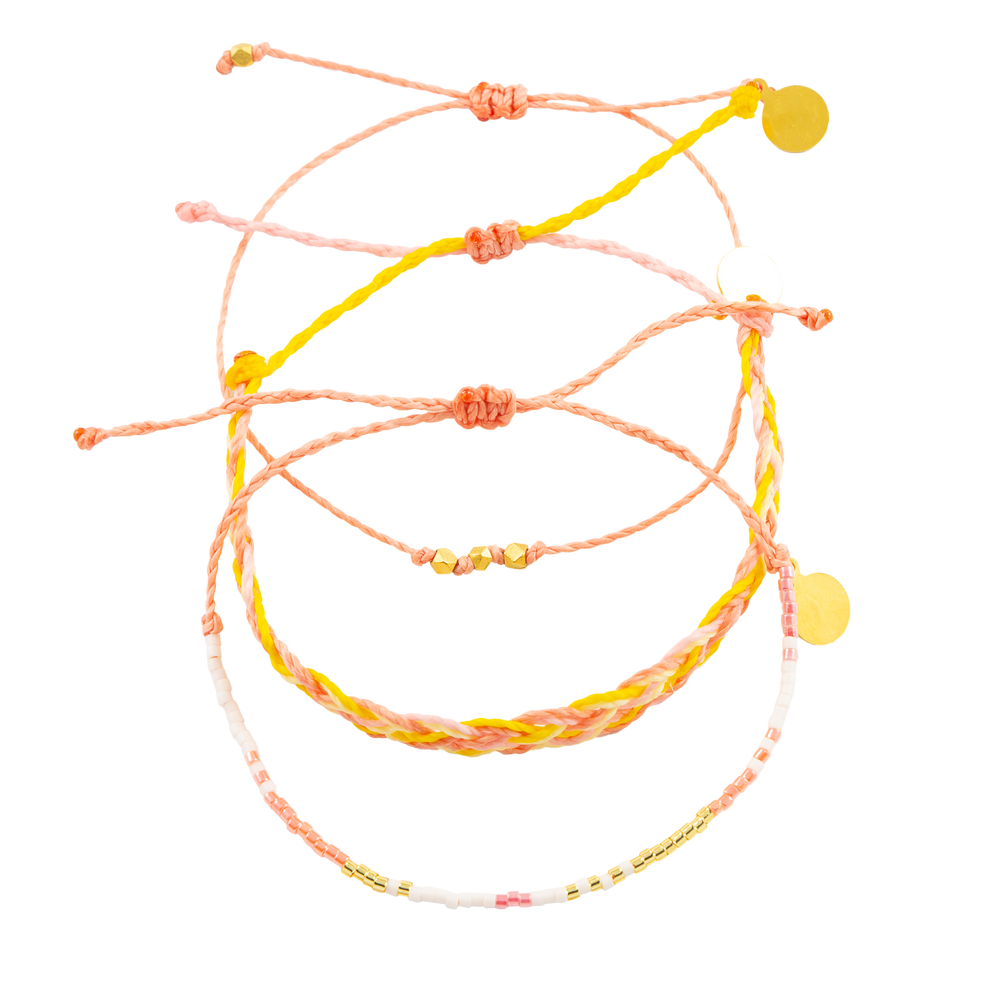 Three Pink Coral Yellow and Gold Bracelets on white shown from the top