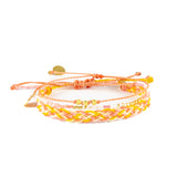 Three pink yellow and coral bracelets show on white front view