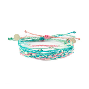 Three pInk & teal bracelets shown on white