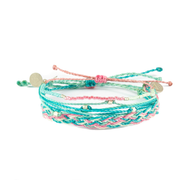 Three pInk & teal bracelets shown on white